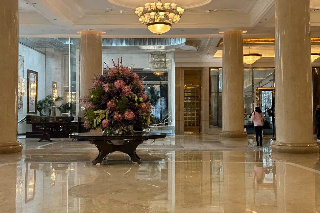 Hotel lobby with marble floor and chandeliers